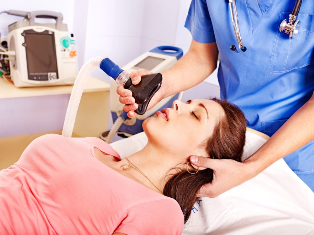 woman comfortably in dentist chair for sedation.